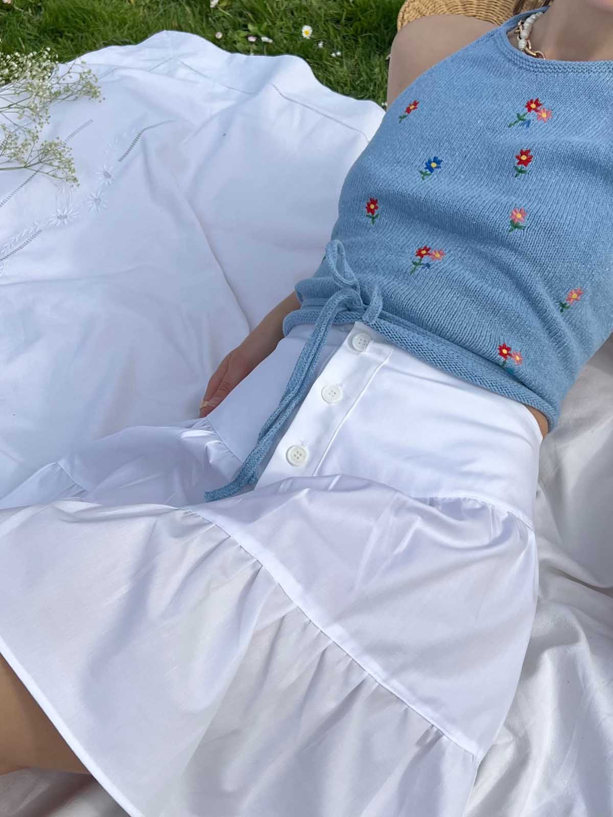 jupe ange en popeline blanche portée en extérieur sur un draps blanc 